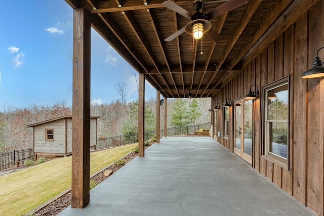 view of patio / terrace with fence, ceiling fan, and french doors