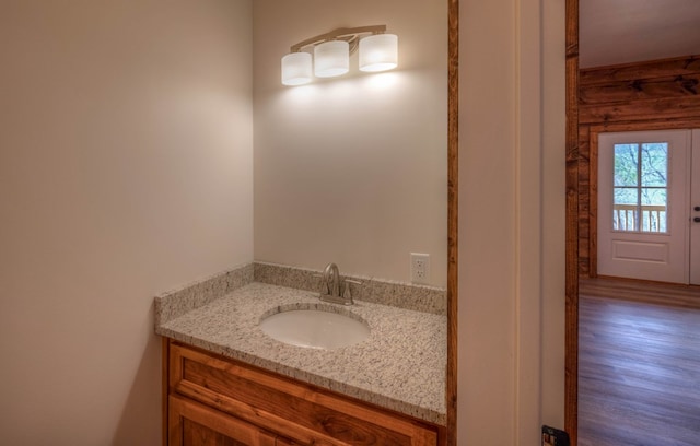 bathroom with hardwood / wood-style floors and vanity