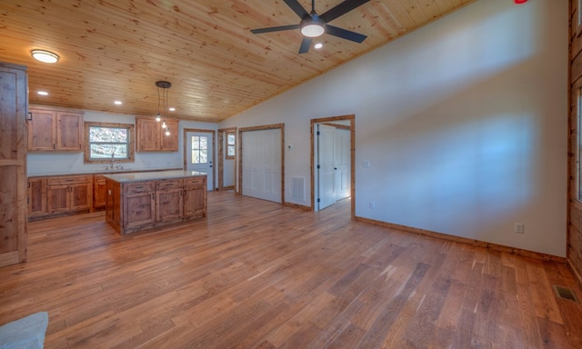 kitchen featuring hanging light fixtures, wood ceiling, wood-type flooring, ceiling fan, and a kitchen island