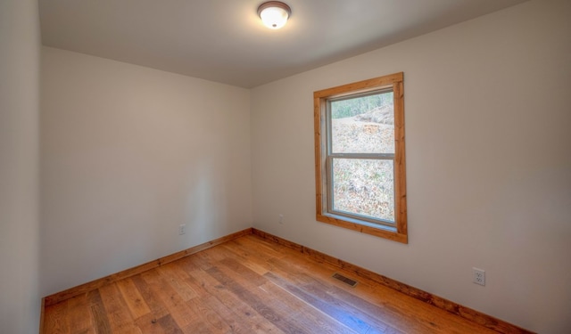 spare room featuring light wood-type flooring