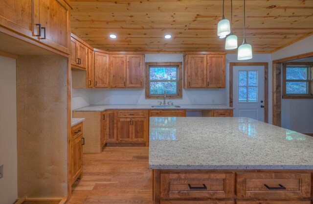 unfurnished bedroom featuring a closet, wood ceiling, light hardwood / wood-style floors, and vaulted ceiling