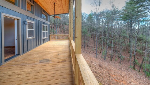 sunroom featuring wooden ceiling, an outdoor stone fireplace, ceiling fan, and a wealth of natural light