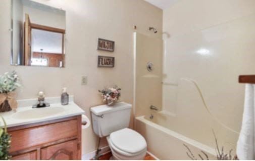 full bath with toilet, shower / tub combination, and vanity