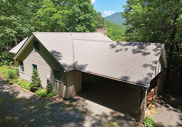 8300 Soapstone Creek Cir, Hiawassee, GA 30546 - view of home's exterior featuring a metal roof, a chimney, driveway, and a mountain view