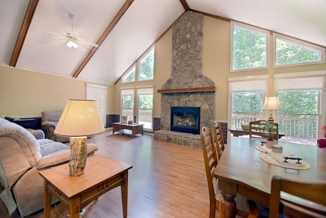 8300 Soapstone Creek Cir, Hiawassee, GA 30546 - living room with high vaulted ceiling, wood finished floors, a fireplace, a ceiling fan, and beamed ceiling