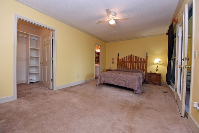 8300 Soapstone Creek Cir, Hiawassee, GA 30546 - carpeted bedroom featuring crown molding, a textured ceiling, a walk in closet, a ceiling fan, and connected bathroom