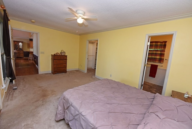 8300 Soapstone Creek Cir, Hiawassee, GA 30546 - carpeted bedroom with ornamental molding, a textured ceiling, connected bathroom, a spacious closet, and a ceiling fan