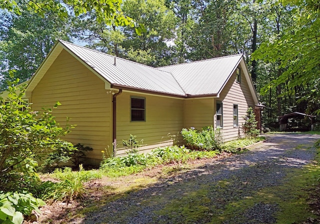 8300 Soapstone Creek Cir, Hiawassee, GA 30546 - view of side of home with a metal roof and driveway