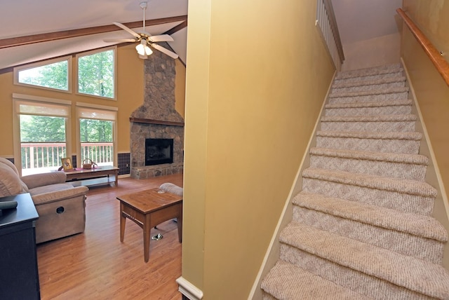 8300 Soapstone Creek Cir, Hiawassee, GA 30546 - stairway with wood finished floors, ceiling fan, beam ceiling, high vaulted ceiling, and a fireplace