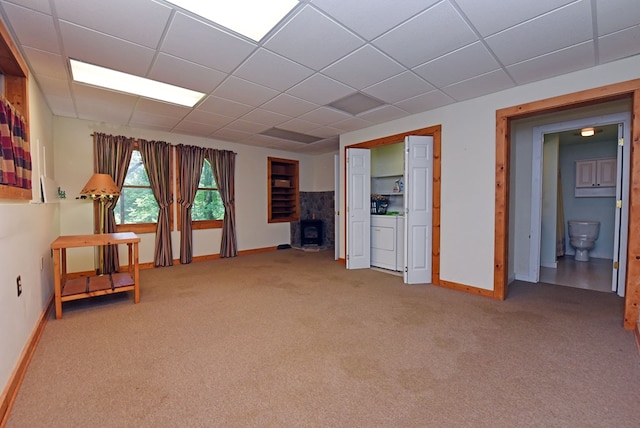 8300 Soapstone Creek Cir, Hiawassee, GA 30546 - carpeted empty room featuring washer / dryer, a wood stove, and a drop ceiling
