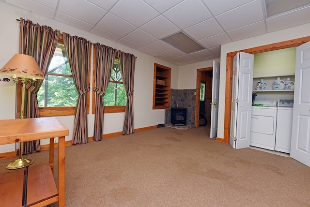 8300 Soapstone Creek Cir, Hiawassee, GA 30546 - living room featuring washing machine and dryer, light colored carpet, a drop ceiling, and a wood stove