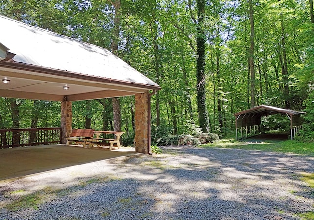 8300 Soapstone Creek Cir, Hiawassee, GA 30546 - view of home's community featuring a carport, driveway, and a wooded view
