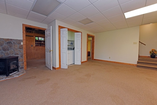 8300 Soapstone Creek Cir, Hiawassee, GA 30546 - unfurnished living room with washer / clothes dryer, a wood stove, stairway, carpet, and a drop ceiling