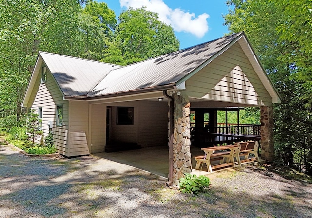 8300 Soapstone Creek Cir, Hiawassee, GA 30546 - view of front of home featuring an attached carport, a metal roof, and gravel driveway