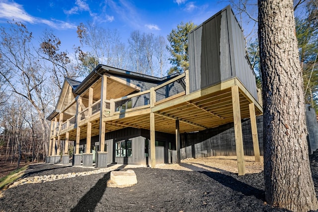 back of property featuring a wooden deck