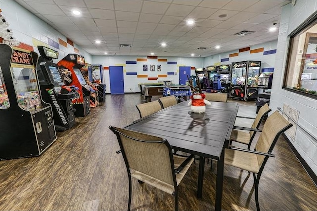 dining area featuring dark hardwood / wood-style flooring and a drop ceiling