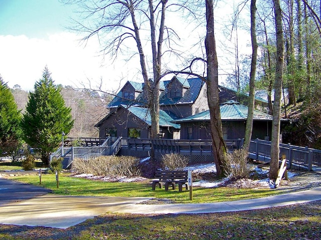 view of side of property with a yard and a wooden deck