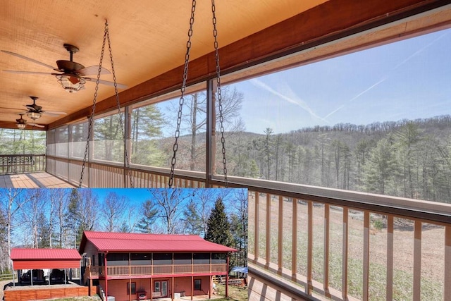 sunroom / solarium with ceiling fan and a forest view