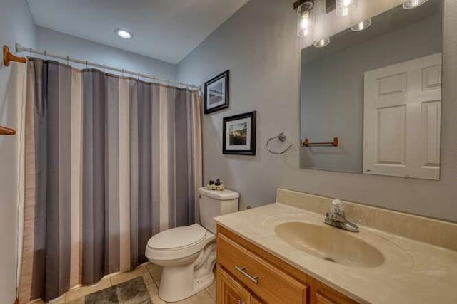 bathroom featuring toilet, tile patterned floors, a shower with shower curtain, and vanity