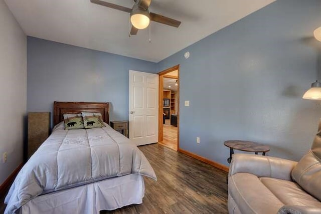 bedroom featuring a ceiling fan, baseboards, and dark wood-style flooring