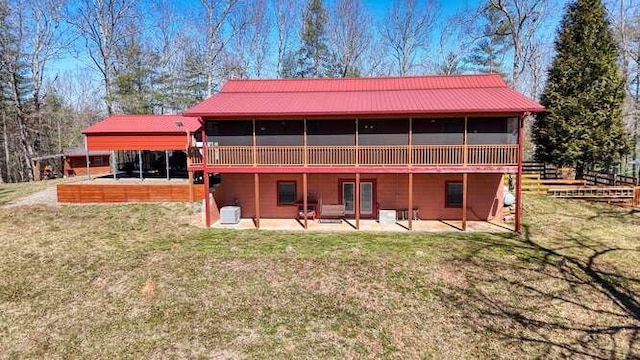 back of house with a patio, a sunroom, metal roof, a yard, and central air condition unit