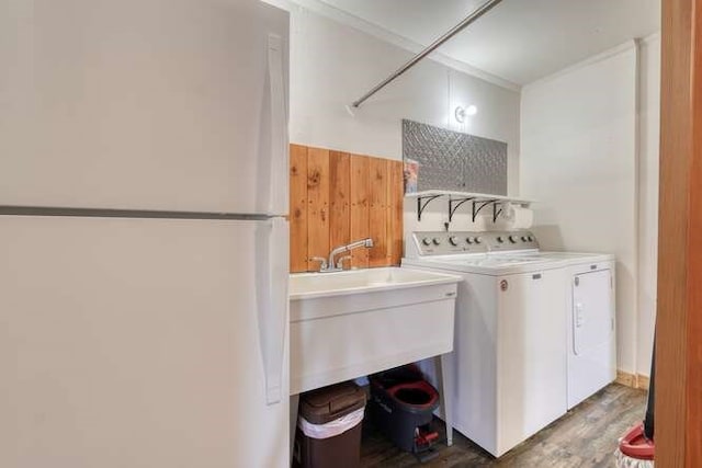 laundry room featuring laundry area, ornamental molding, and washer and dryer