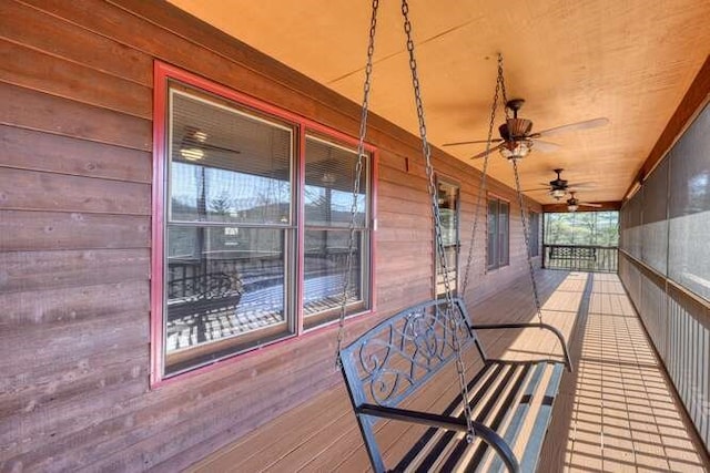 wooden terrace featuring ceiling fan