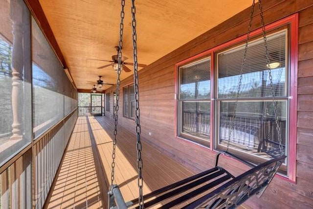 wooden deck with a ceiling fan