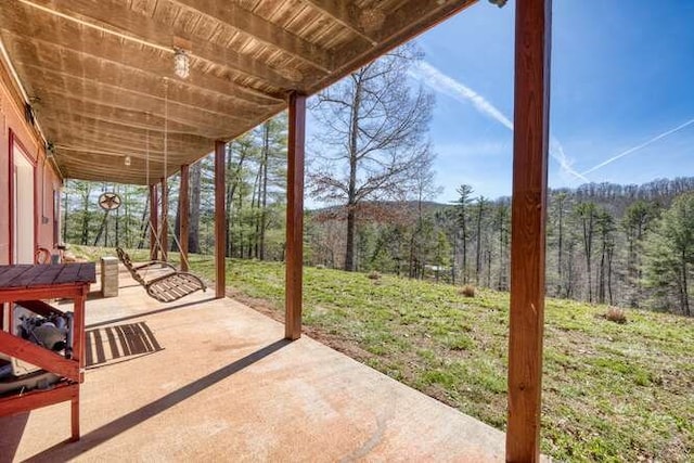 view of patio / terrace with a wooded view