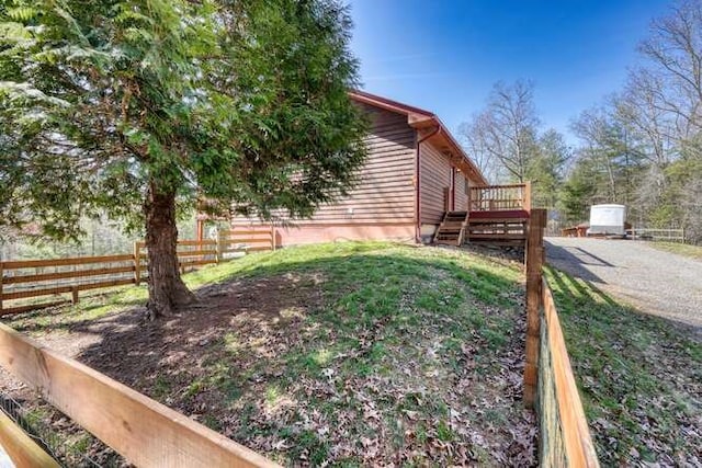 view of yard with fence and a wooden deck