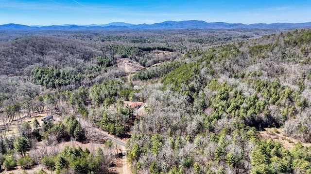 drone / aerial view with a mountain view and a wooded view