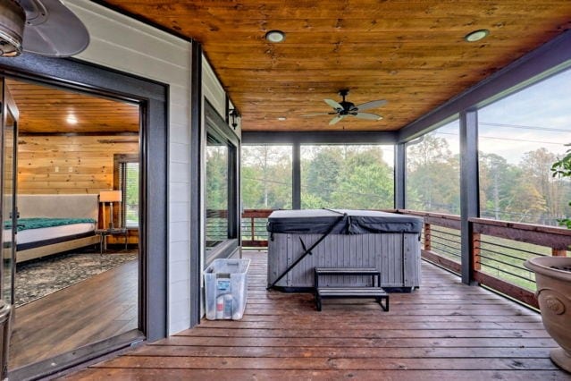 sunroom with ceiling fan, wooden ceiling, and a hot tub