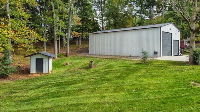 view of yard featuring a garage and a storage shed