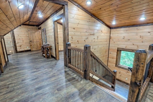 bonus room featuring wood walls, wood ceiling, and dark hardwood / wood-style floors