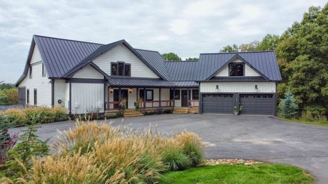 modern farmhouse featuring a porch and a garage