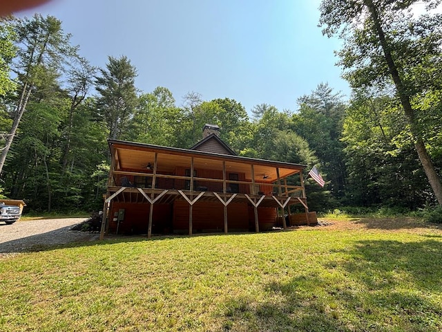 2726 Turkey Trot Rd, Hiawassee, GA 30546 - back of house with a yard, a deck, a forest view, and a chimney