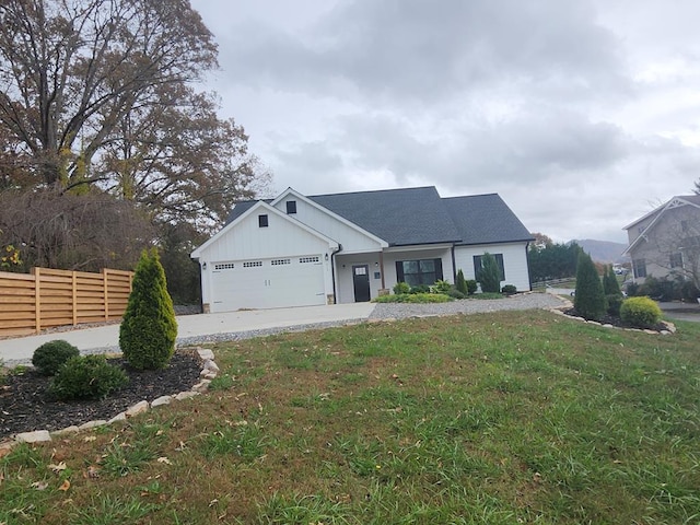 view of front of house featuring a garage and a front yard