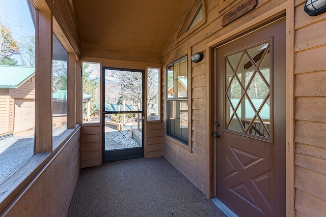 unfurnished sunroom with vaulted ceiling