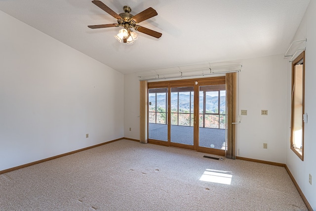 carpeted spare room featuring ceiling fan and a textured ceiling