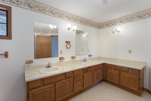 bathroom with vanity and a textured ceiling