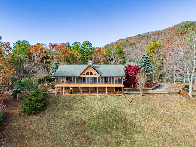 exterior space featuring a mountain view and a sunroom