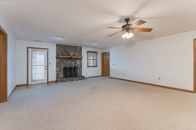 unfurnished living room with ceiling fan, carpet floors, and a textured ceiling