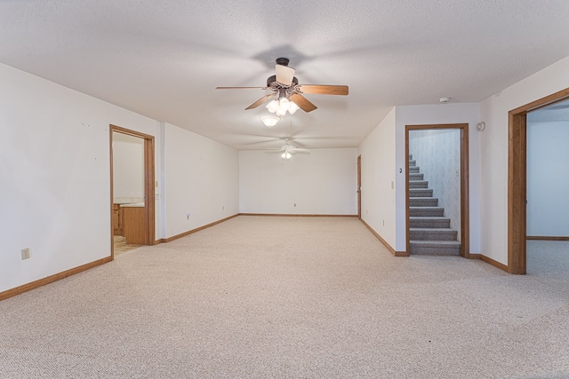 interior space featuring light carpet, a textured ceiling, and ceiling fan