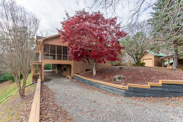 view of front of home with a carport and a sunroom