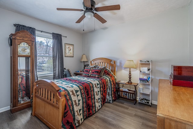 bedroom featuring wood finished floors, ceiling fan, and baseboards