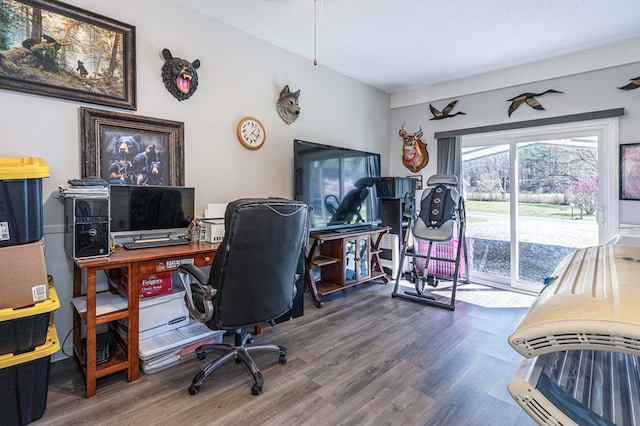 office with wood finished floors and a textured ceiling