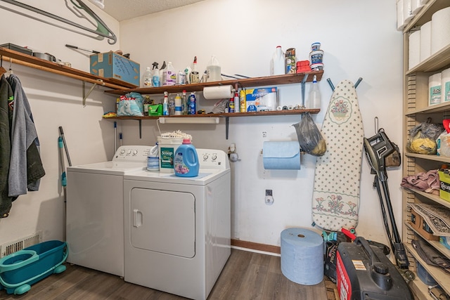 laundry room with washing machine and clothes dryer and dark wood-style flooring