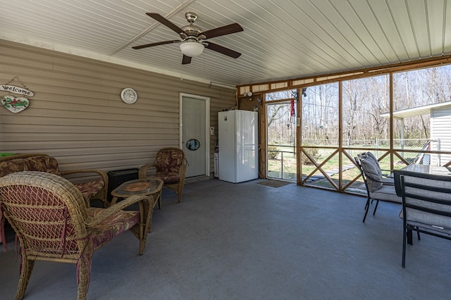 sunroom featuring ceiling fan, outdoor dining space, and plenty of natural light