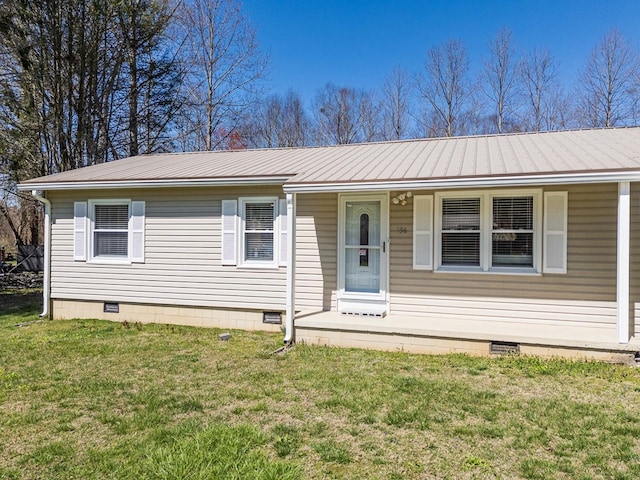single story home featuring crawl space, covered porch, metal roof, and a front yard