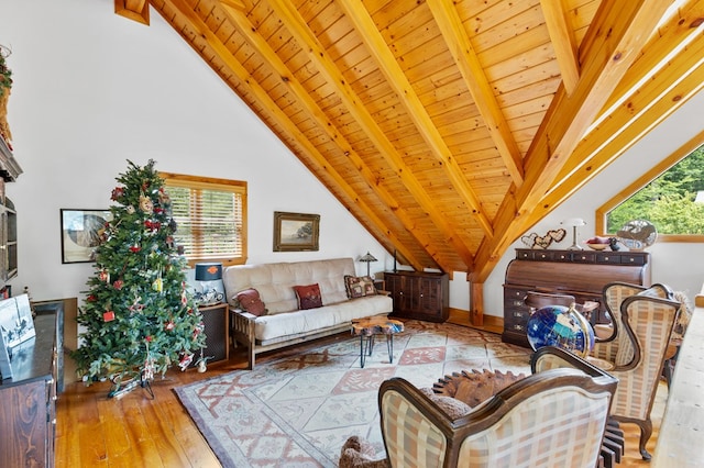 living room with vaulted ceiling with beams, a healthy amount of sunlight, and light wood-type flooring